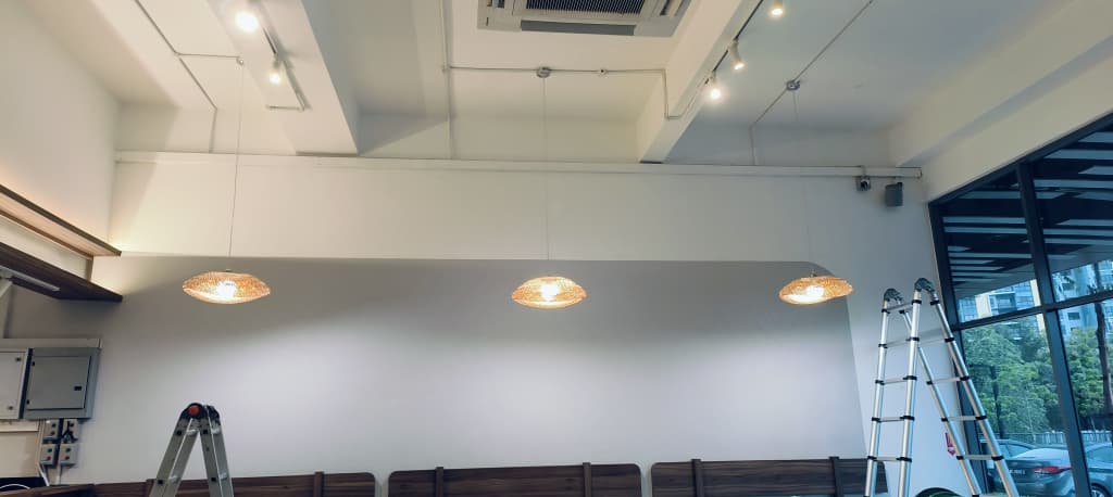 Commercial cafe ceiling with cassette air-conditioner, track lights and pendant lighting